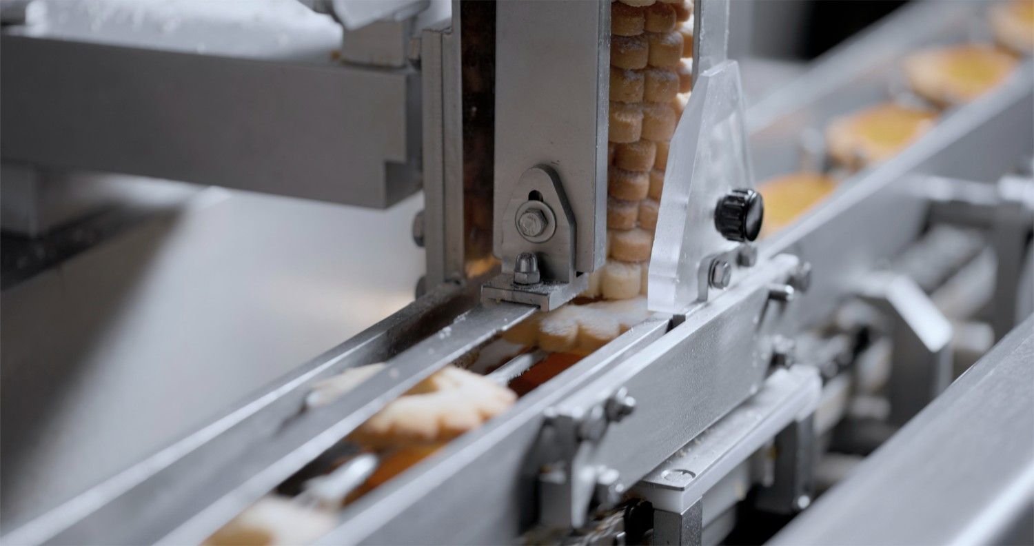 Cookies passing through machine in baking factory