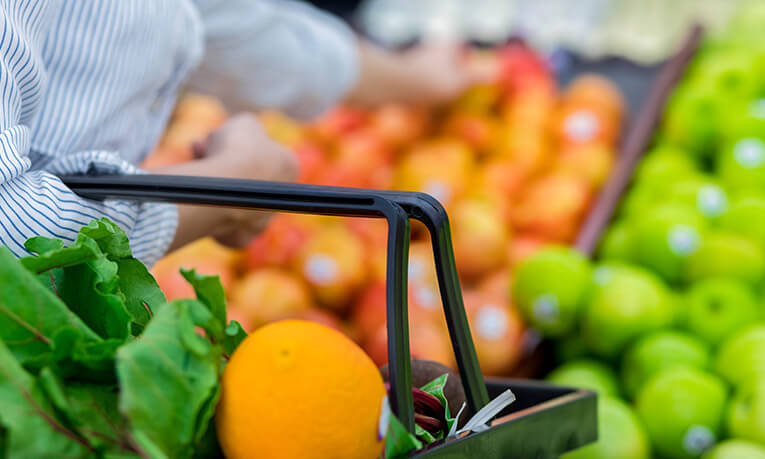 Woman shopping vegetables in store